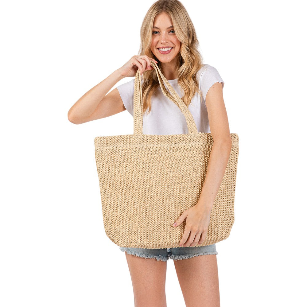 Beige Solid Crochet Straw Tote Bag is perfect for a day at the beach. Made from durable straw material, it features a spacious interior and sturdy handles for carrying all your essentials. Stay stylish and organized with this must-have accessory.