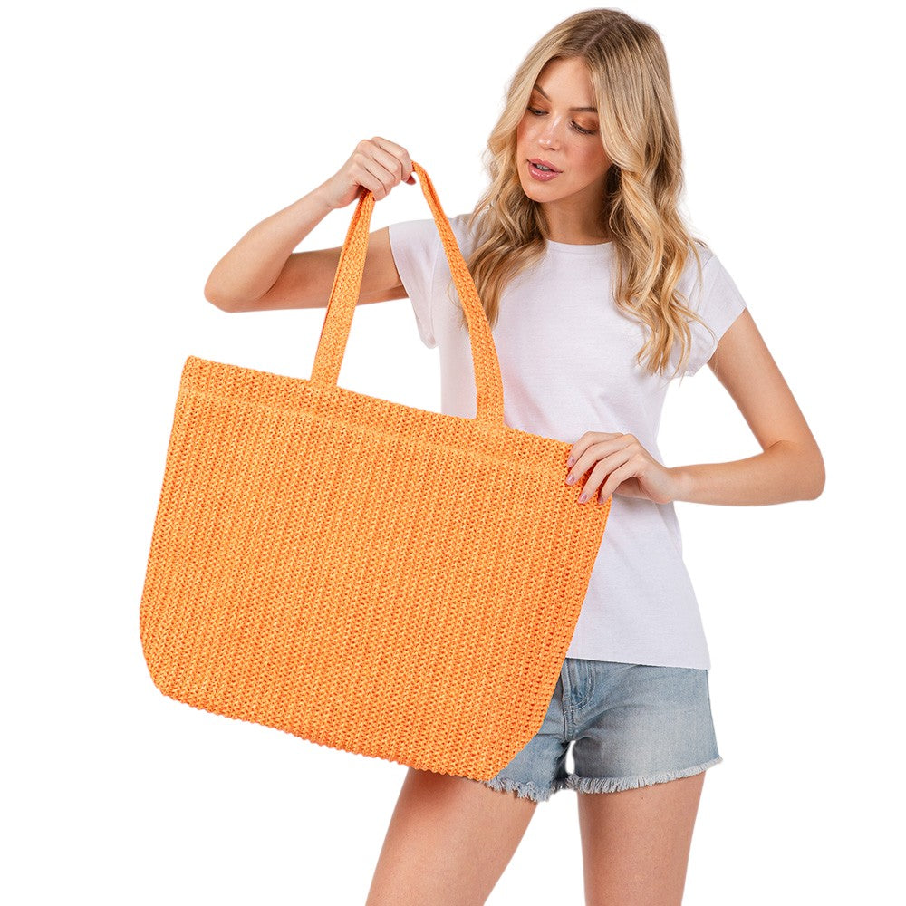 Orange Solid Crochet Straw Tote Bag is perfect for a day at the beach. Made from durable straw material, it features a spacious interior and sturdy handles for carrying all your essentials. Stay stylish and organized with this must-have accessory.