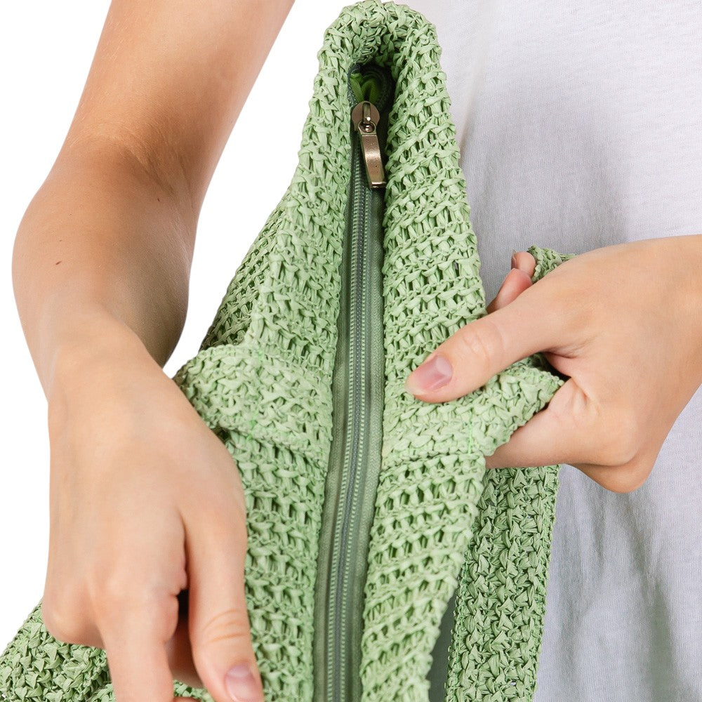Olive Green Solid Crochet Straw Tote Bag is perfect for a day at the beach. Made from durable straw material, it features a spacious interior and sturdy handles for carrying all your essentials. Stay stylish and organized with this must-have accessory.
