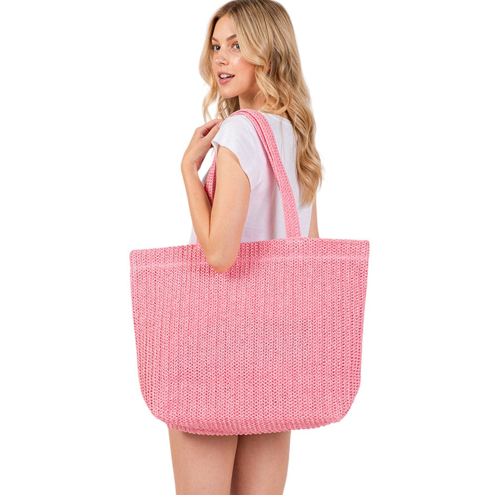 Pink Solid Crochet Straw Tote Bag is perfect for a day at the beach. Made from durable straw material, it features a spacious interior and sturdy handles for carrying all your essentials. Stay stylish and organized with this must-have accessory.