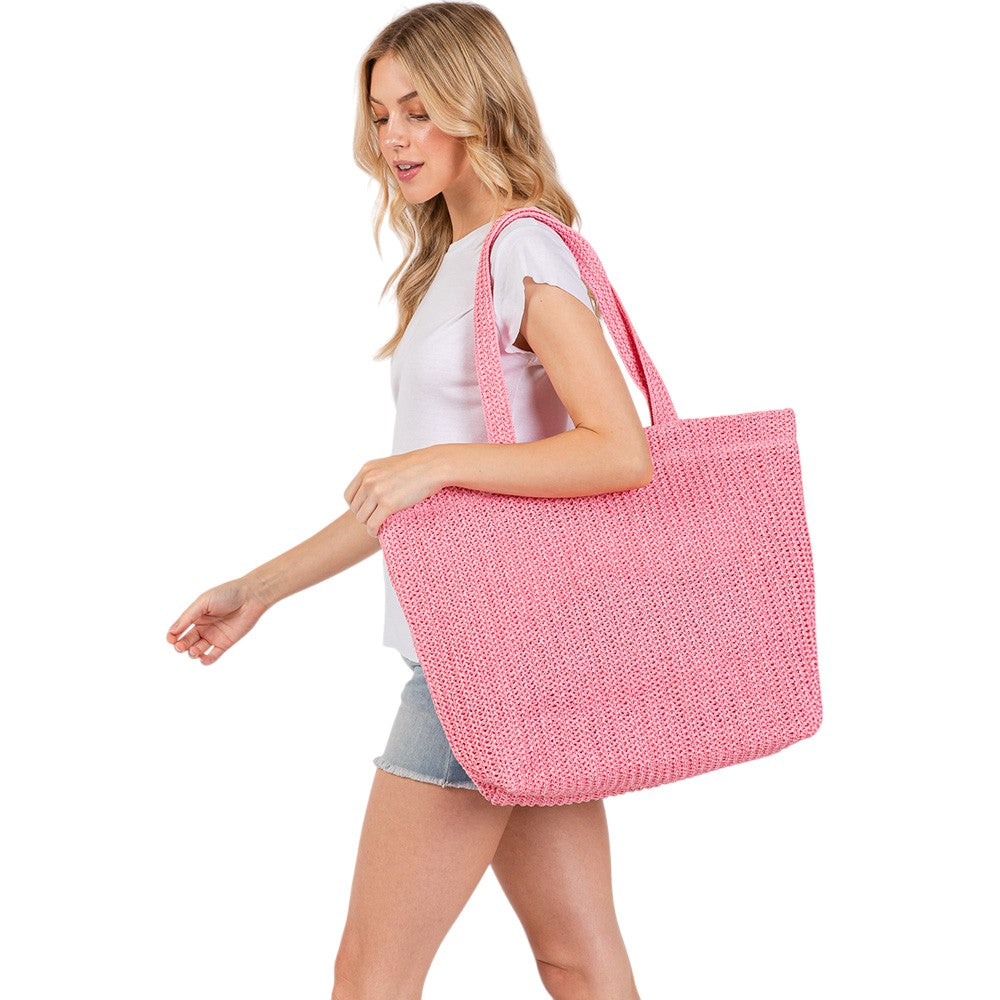 Pink Solid Crochet Straw Tote Bag is perfect for a day at the beach. Made from durable straw material, it features a spacious interior and sturdy handles for carrying all your essentials. Stay stylish and organized with this must-have accessory.