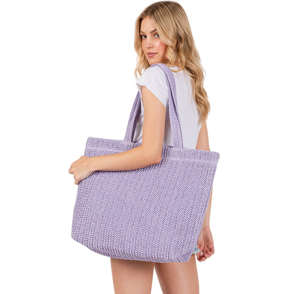 Purple Solid Crochet Straw Tote Bag is perfect for a day at the beach. Made from durable straw material, it features a spacious interior and sturdy handles for carrying all your essentials. Stay stylish and organized with this must-have accessory.