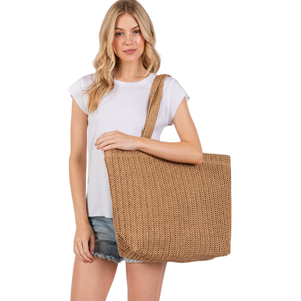 Taupe Solid Crochet Straw Tote Bag is perfect for a day at the beach. Made from durable straw material, it features a spacious interior and sturdy handles for carrying all your essentials. Stay stylish and organized with this must-have accessory.
