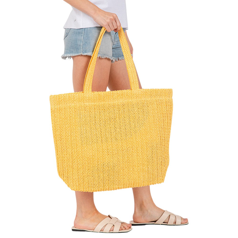Yellow Solid Crochet Straw Tote Bag is perfect for a day at the beach. Made from durable straw material, it features a spacious interior and sturdy handles for carrying all your essentials. Stay stylish and organized with this must-have accessory.