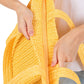 Yellow Solid Crochet Straw Tote Bag is perfect for a day at the beach. Made from durable straw material, it features a spacious interior and sturdy handles for carrying all your essentials. Stay stylish and organized with this must-have accessory.