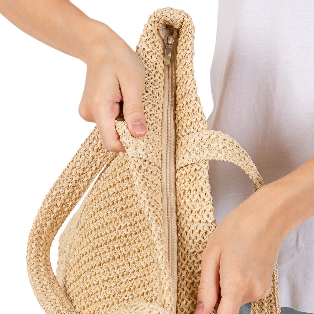 Beige Solid Crochet Straw Tote Bag is perfect for a day at the beach. Made from durable straw material, it features a spacious interior and sturdy handles for carrying all your essentials. Stay stylish and organized with this must-have accessory.