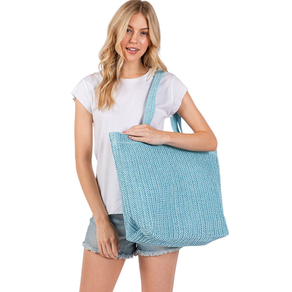 Blue Solid Crochet Straw Tote Bag is perfect for a day at the beach. Made from durable straw material, it features a spacious interior and sturdy handles for carrying all your essentials. Stay stylish and organized with this must-have accessory.