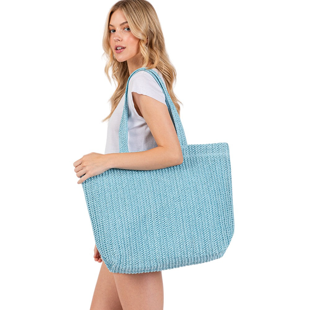 Blue Solid Crochet Straw Tote Bag is perfect for a day at the beach. Made from durable straw material, it features a spacious interior and sturdy handles for carrying all your essentials. Stay stylish and organized with this must-have accessory.