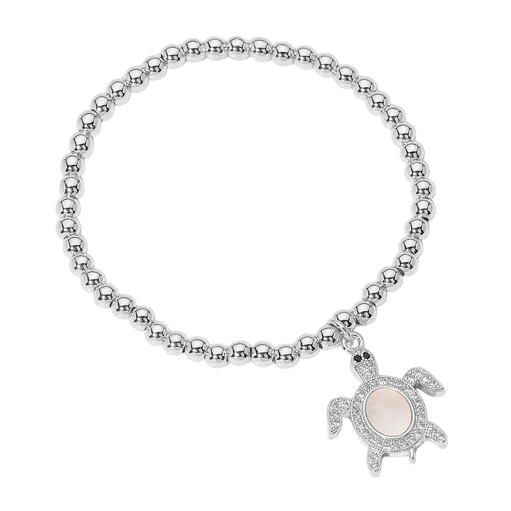 Silver Stainless Steel Ball Mother of Pearl Sea Turtle Charm Beaded Stretch Bracelet combines a beautiful mother of pearl sea turtle charm with durable stainless steel and effortless stretch design. Show your love for the sea and add a touch of elegance to any outfit. Expertly crafted for lasting beauty. 