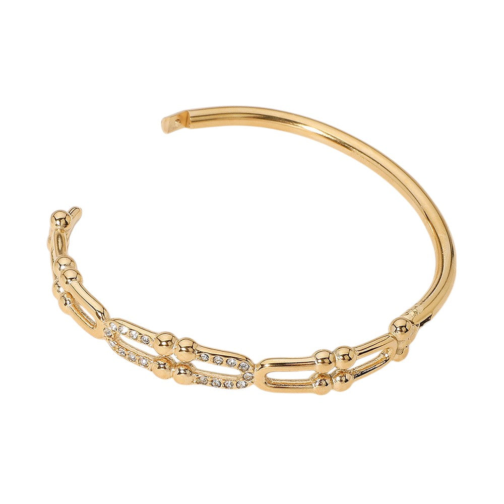 Gold Stainless Steel Stone Paved Abstract Hinged Bangle Bracelet boasts a timeless design and high-quality construction. Made with durable stainless steel and accented with sparkling stones, this bracelet elevates any look. Its hinged closure ensures a secure fit, making it perfect for everyday wear.