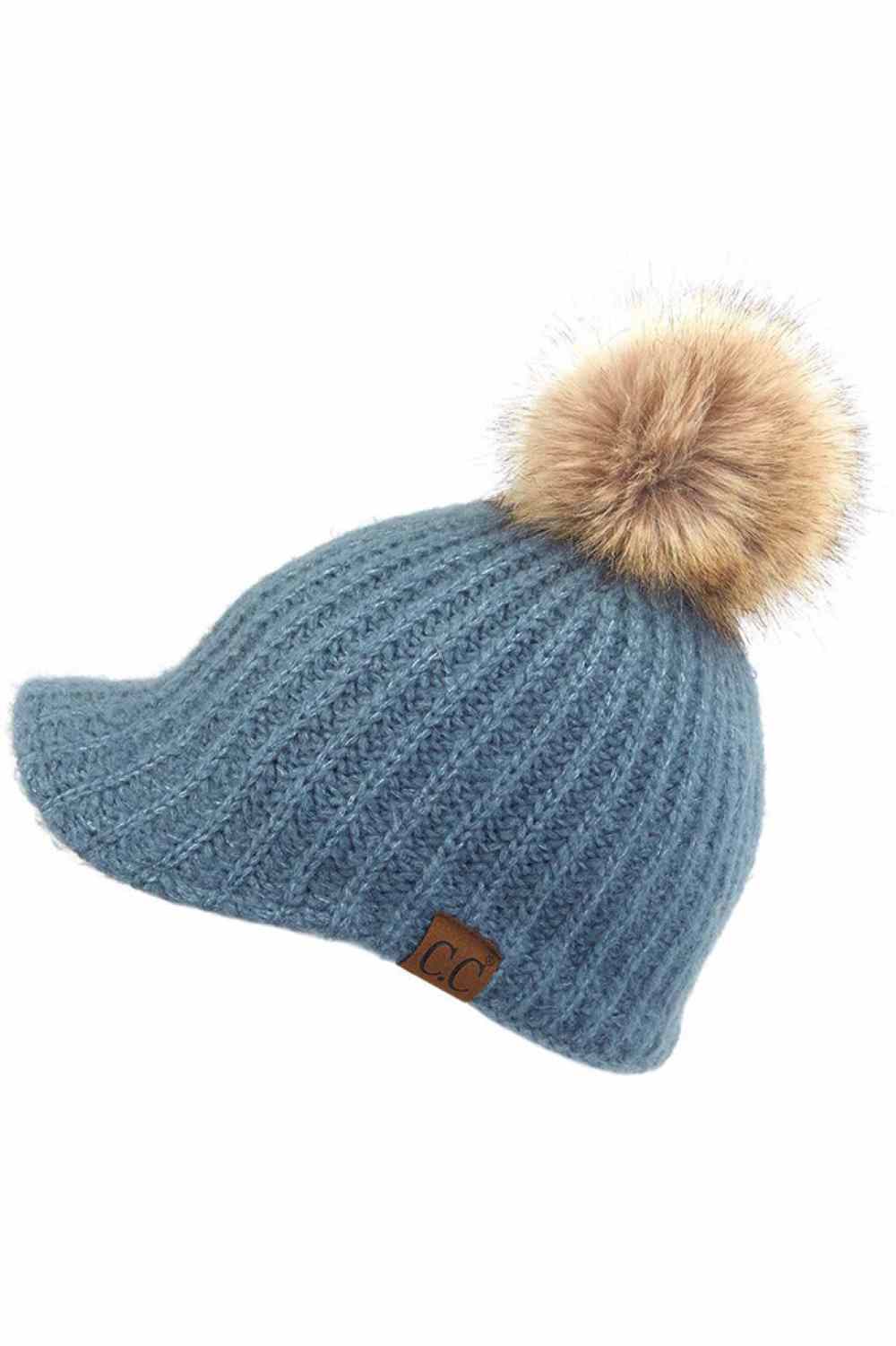 Steel Blue Stay cozy with this knitted brim beanie featuring a plush pom pom detail. Crafted from a soft blend of 75% acrylic, 22% polyester, and 3% spandex, this winter essential delivers warmth and comfort in a versatile style. Available in nine rich colors including Beige, Berry, Dark Denim, Heather Gray, Ivory, Pistachio, Rose, Steel Blue, and Violet Purple. The ribbed knit construction and faux fur pom add texture and visual interest to any cold-weather outfit. Hand wash and lay flat to dry for lasting