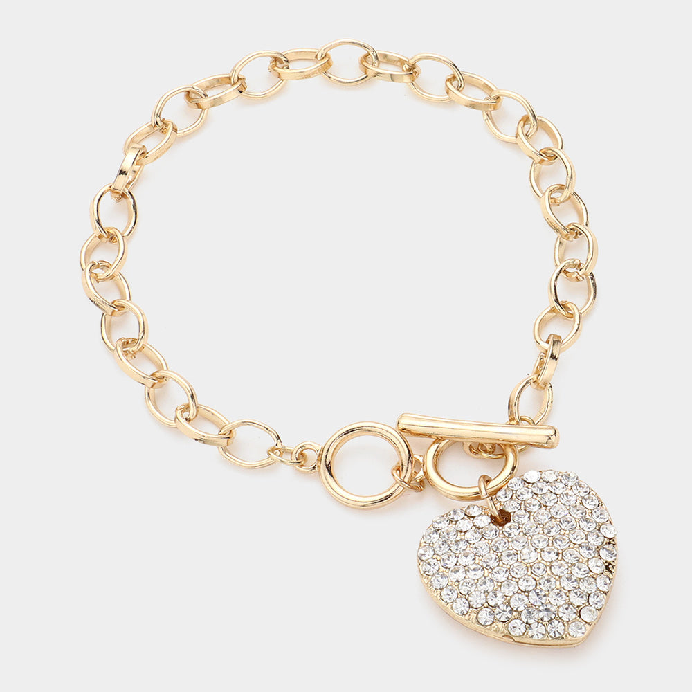 Stone Paved Heart Pendant Metal Toggle Bracelet is expertly crafted with a beautiful stone paved heart pendant and a durable metal toggle closure. The perfect accessory for any occasion, adding a touch of elegance and style to any outfit. Experience its timeless charm and versatility today.