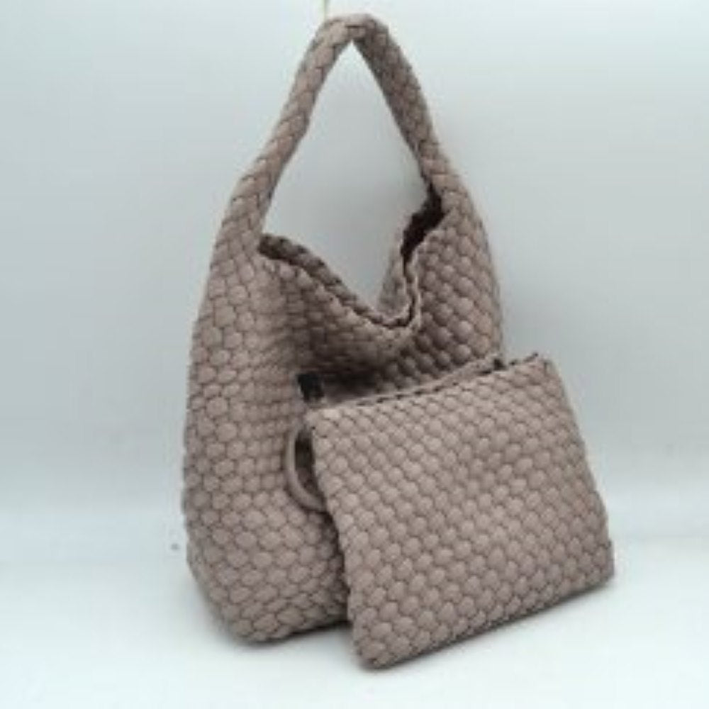 Stone This stylish everyday hobo bag features an all-over classic basket weave design and a slouchy silhouette. It is crafted with a seamless, integrated wide top handle that transitions directly into the main storage compartment for comfortable hand or shoulder carrying.