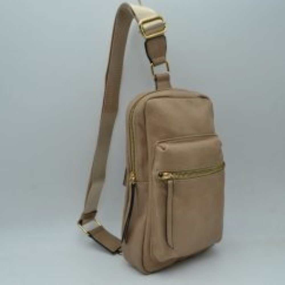 Stone This functional sling bag features a textured, grained finish exterior designed for streamlined everyday use. It offers multiple practical storage compartments, including a curved main section secured by a prominent metallic zipper track and a secondary front pocket with a horizontal zipper and an elongated pull tab. The bag is equipped with a single wide shoulder strap that attaches via a rectangular loop and incorporates an adjustable metallic buckle to easily customize the carrying length.