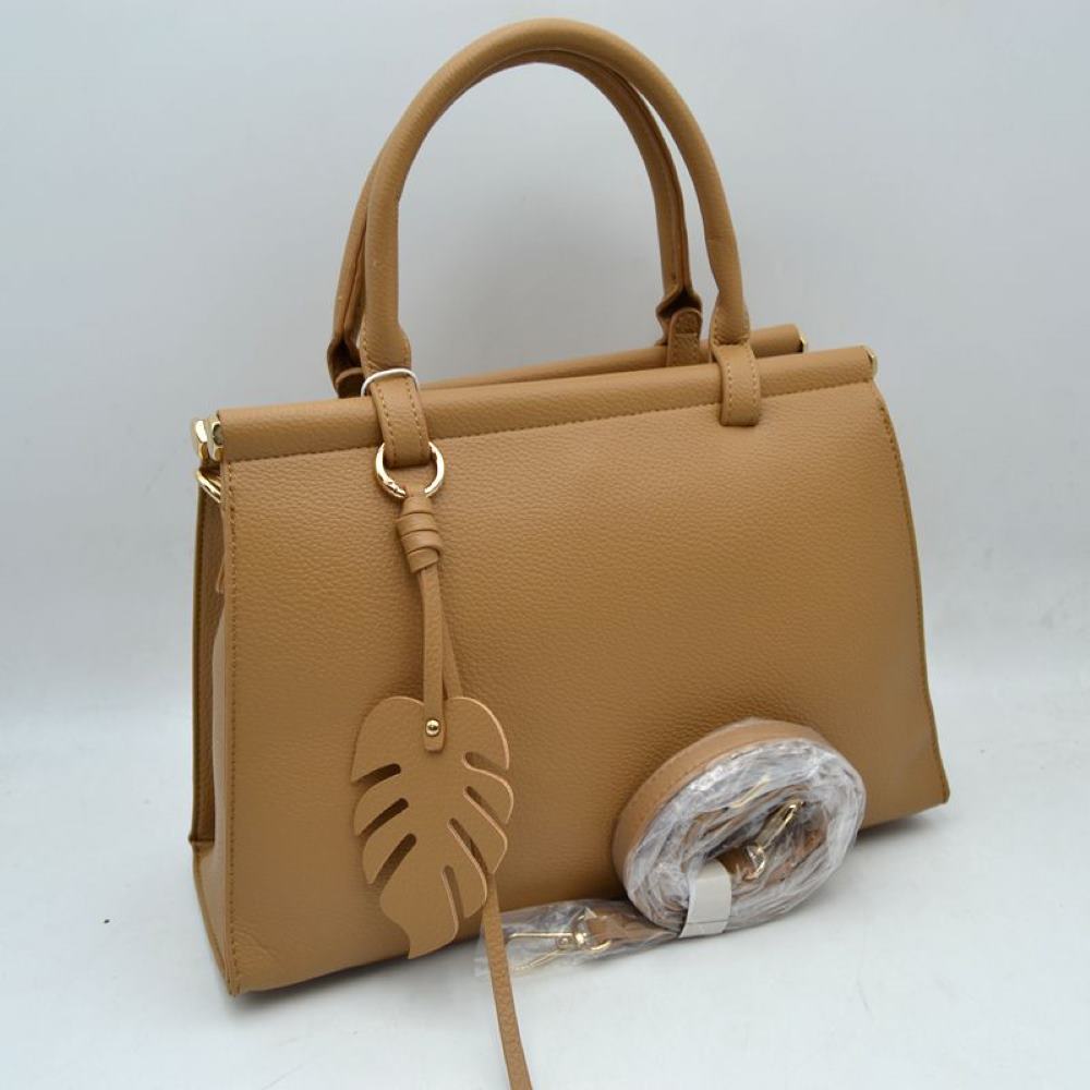Tan This stylish structured handbag is designed for everyday elegance and practicality. Crafted with a premium textured finish, it features a sleek top-handle design with gold-tone hardware accents for a luxurious touch. The spacious interior provides enough room for daily essentials like phone, wallet, cosmetics, and small accessories, making it perfect for both office and casual use. It also comes with a detachable and adjustable shoulder strap for versatile carrying options.