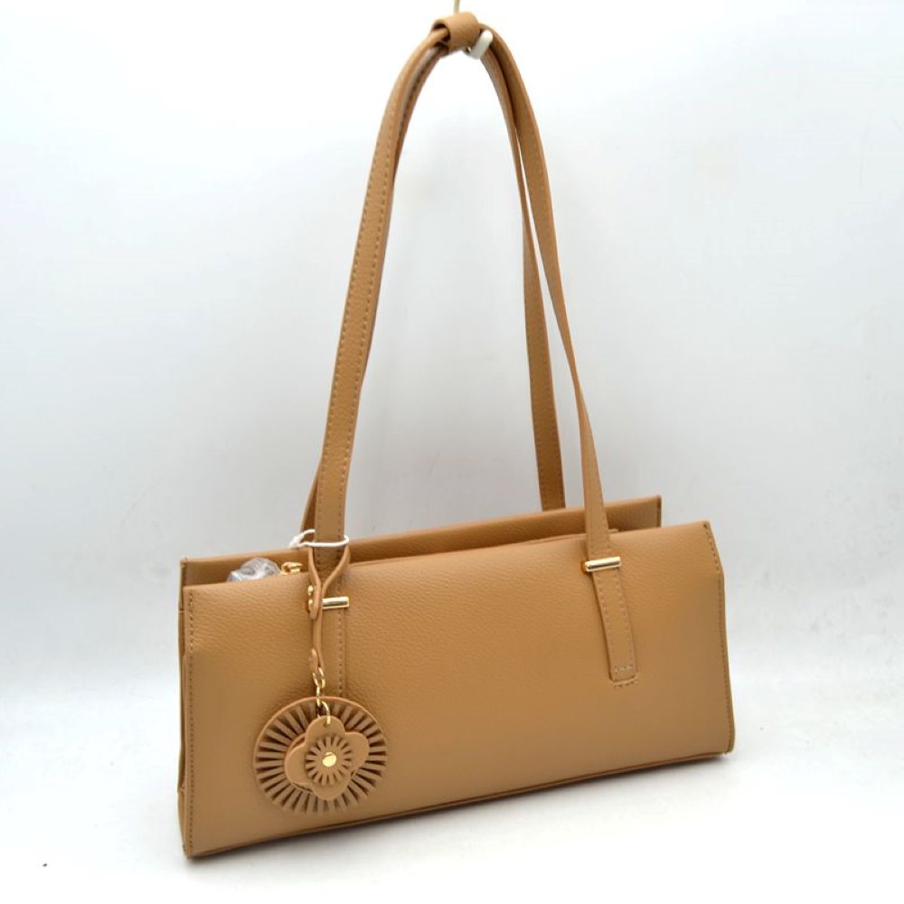 Tan Upgrade your everyday style with this sleek and sophisticated black shoulder tote bag. Designed with a modern rectangular silhouette, this handbag combines elegance and practicality for daily use. Crafted from textured faux leather, it features comfortable shoulder straps, a spacious interior, and a stylish decorative charm for a fashionable finishing touch. Perfect for work, shopping, casual outings, or evening occasions, this versatile bag complements both formal and casual wardrobes.