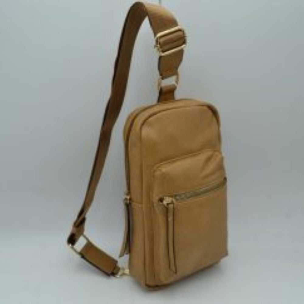 Tan This functional sling bag features a textured, grained finish exterior designed for streamlined everyday use. It offers multiple practical storage compartments, including a curved main section secured by a prominent metallic zipper track and a secondary front pocket with a horizontal zipper and an elongated pull tab. The bag is equipped with a single wide shoulder strap that attaches via a rectangular loop and incorporates an adjustable metallic buckle to easily customize the carrying length.
