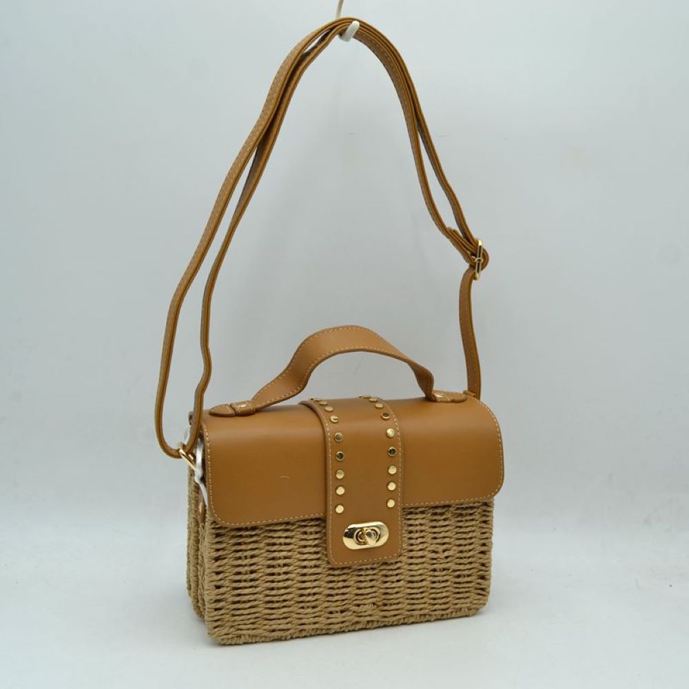 Tan Embrace warm-weather sophistication with this beautiful mixed-media shoulder bag. Effortlessly blending the rustic, organic charm of a woven straw basket body with a smooth, structured faux-leather flap enclosure, this bag is a must-have accessory for casual sunny days, resort vacations, or stylish weekend brunches. Its elegant silhouette offers a refined twist on classic beachwear aesthetics, transitioning perfectly from a day in the sun to an evening out.