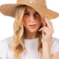 Taupe Evil Eye braided band sun hat offers superior protection against harsh summer rays while maintaining breathability. The distinctive evil eye motif adds a sophisticated touch to casual outfits. Lightweight construction ensures comfort during extended wear, making it an essential accessory for beach outings, garden parties, or everyday sun protection.