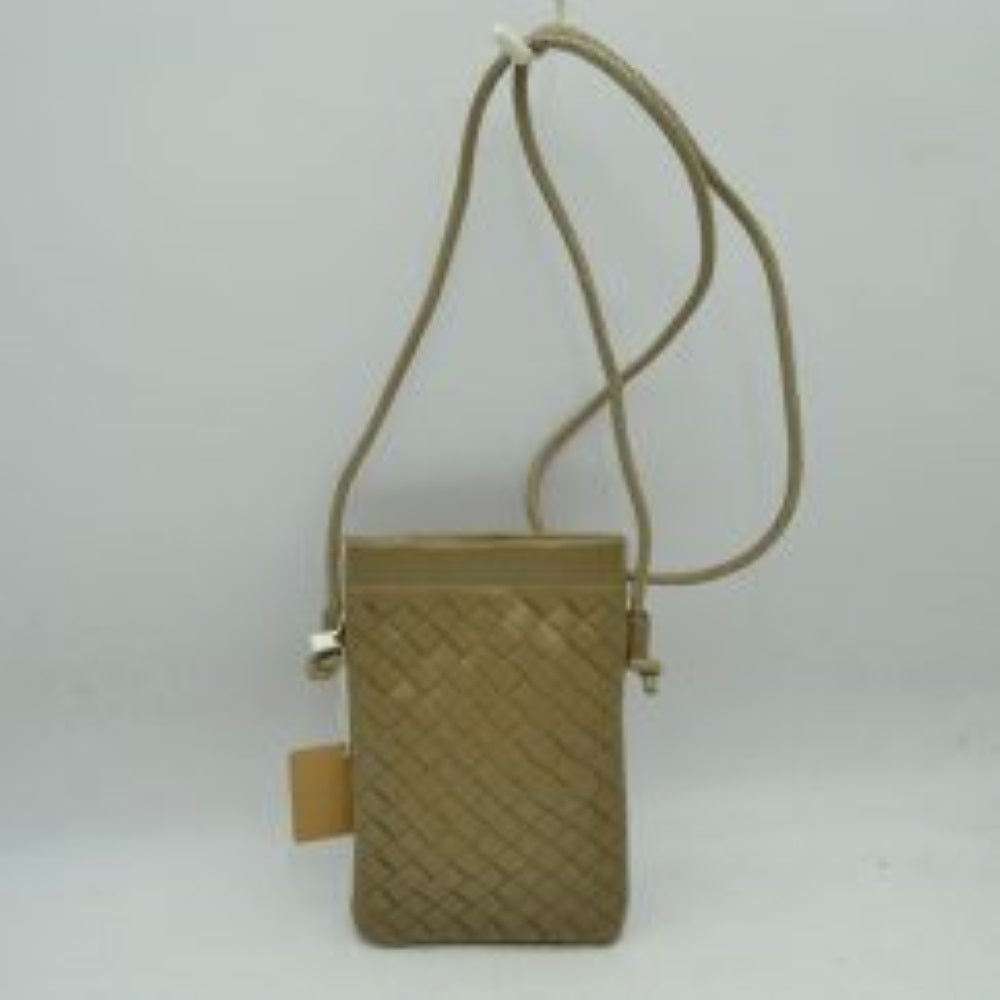 Taupe This compact vertical crossbody bag is designed for everyday functionality with a distinct woven textured pattern across its body. It features a slim, continuous cord strap attached securely to the sides with visible knot details for comfortable carrying. A clean horizontal opening at the top allows effortless access to the main storage compartment