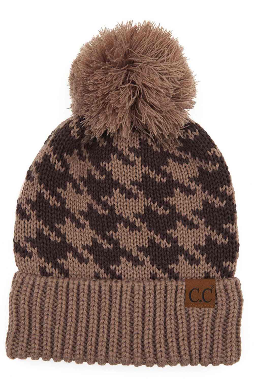 Taupe Elevate your winter wardrobe with the C.C Houndstooth Knit Beanie With Pom. This classic houndstooth pattern beanie combines timeless style with everyday comfort. Made from 100% acrylic, it's lightweight and soft against your skin. The playful pom-pom adds a charming finishing touch.