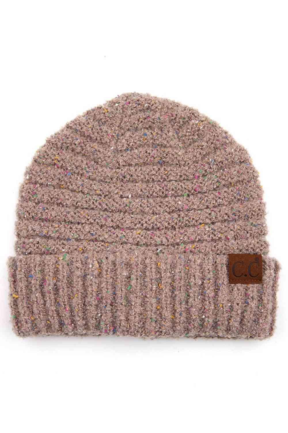 Taupe Elevate your winter wardrobe with this C.C Confetti Boucle Yarn Beanie, crafted from a premium blend of 95% polyester and 5% cotton. The textured boucle yarn creates visual interest and dimension, making it the perfect accessory to complement any outfit.