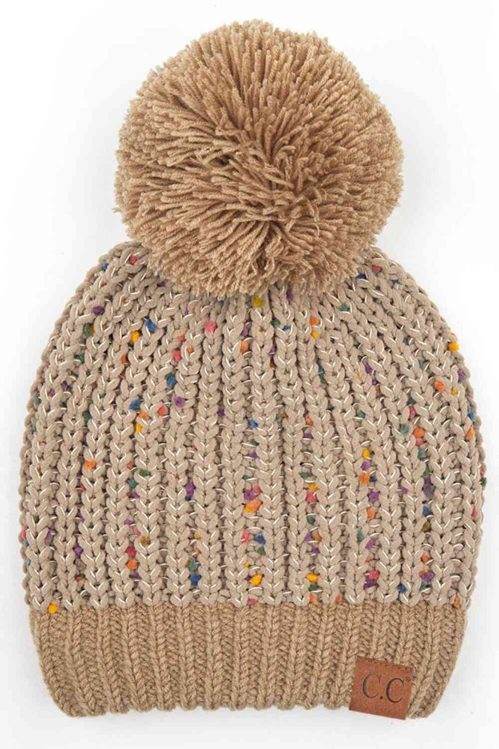 Taupe Elevate your winter wardrobe with this C.C Confetti Chenille Knit Pom Beanie, crafted from a premium blend of 50% acrylic, 43% polyester, and 7% nylon for durability and comfort. The soft chenille knit texture pairs beautifully with a cozy pom detail, making it perfect for both indoor and outdoor wear.