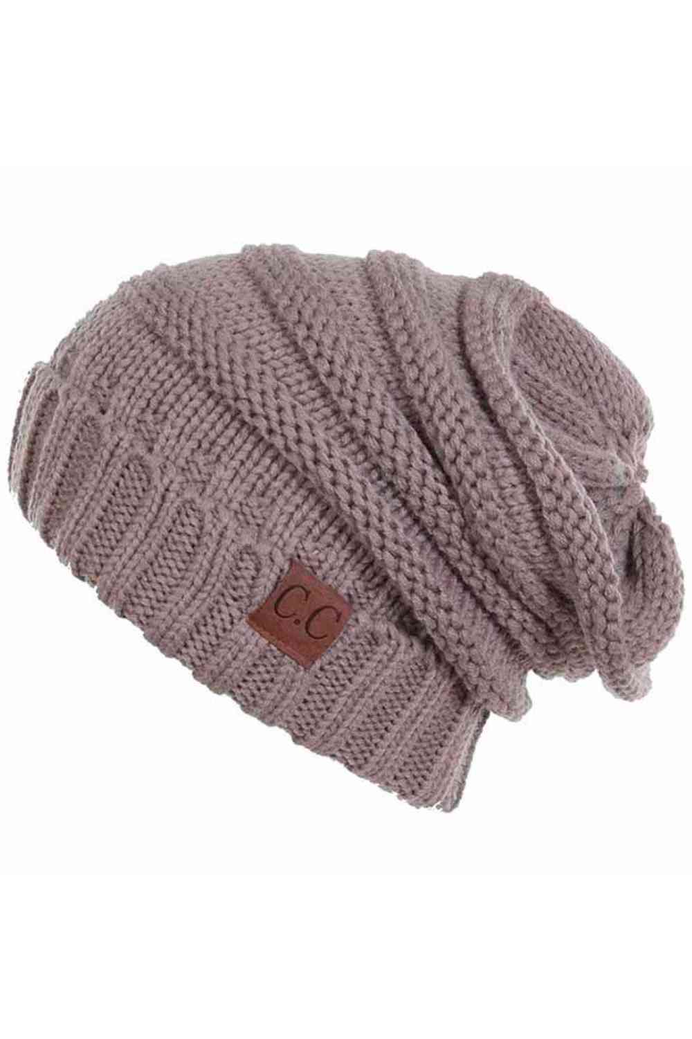 Taupe Wrap yourself in warmth with this C.C Slouchy Knitted Beanie, crafted from 100% soft acrylic for ultimate comfort. The oversized silhouette and plush pom pom detail create a relaxed, on-trend look perfect for chilly days. Available in nine versatile colors—Beige, Berry, Dark Denim, Heather Gray, Ivory, Pistachio, Rose, Steel Blue, and Violet Purple—this beanie pairs effortlessly with any winter wardrobe. The ribbed knit construction ensures durability and a flattering fit.