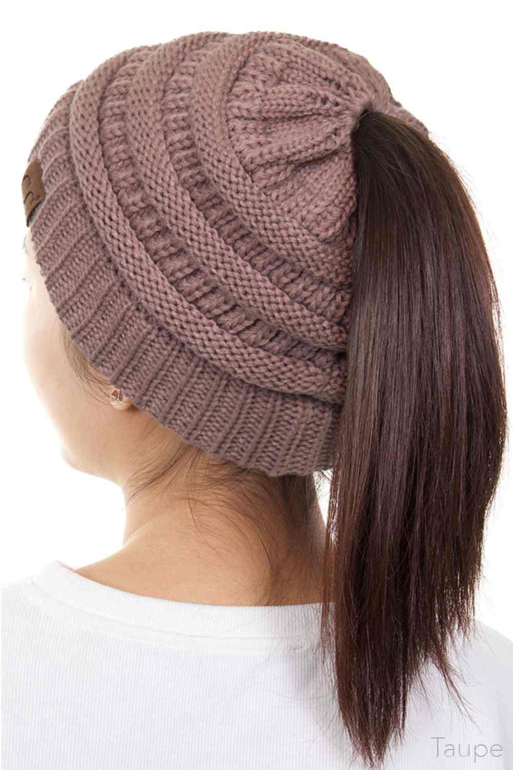 Taupe The C.C Solid Color Ponytail Messy Bun Beanie combines comfort with versatility for effortless everyday style. Crafted from 100% soft acrylic, this beanie features an open crown design that accommodates ponytails and messy buns while keeping you warm. The one-size-fits-most construction ensures a secure, flattering fit for virtually anyone. Perfect for casual outings, workouts, or relaxed weekends, this practical accessory transitions seamlessly from season to season.