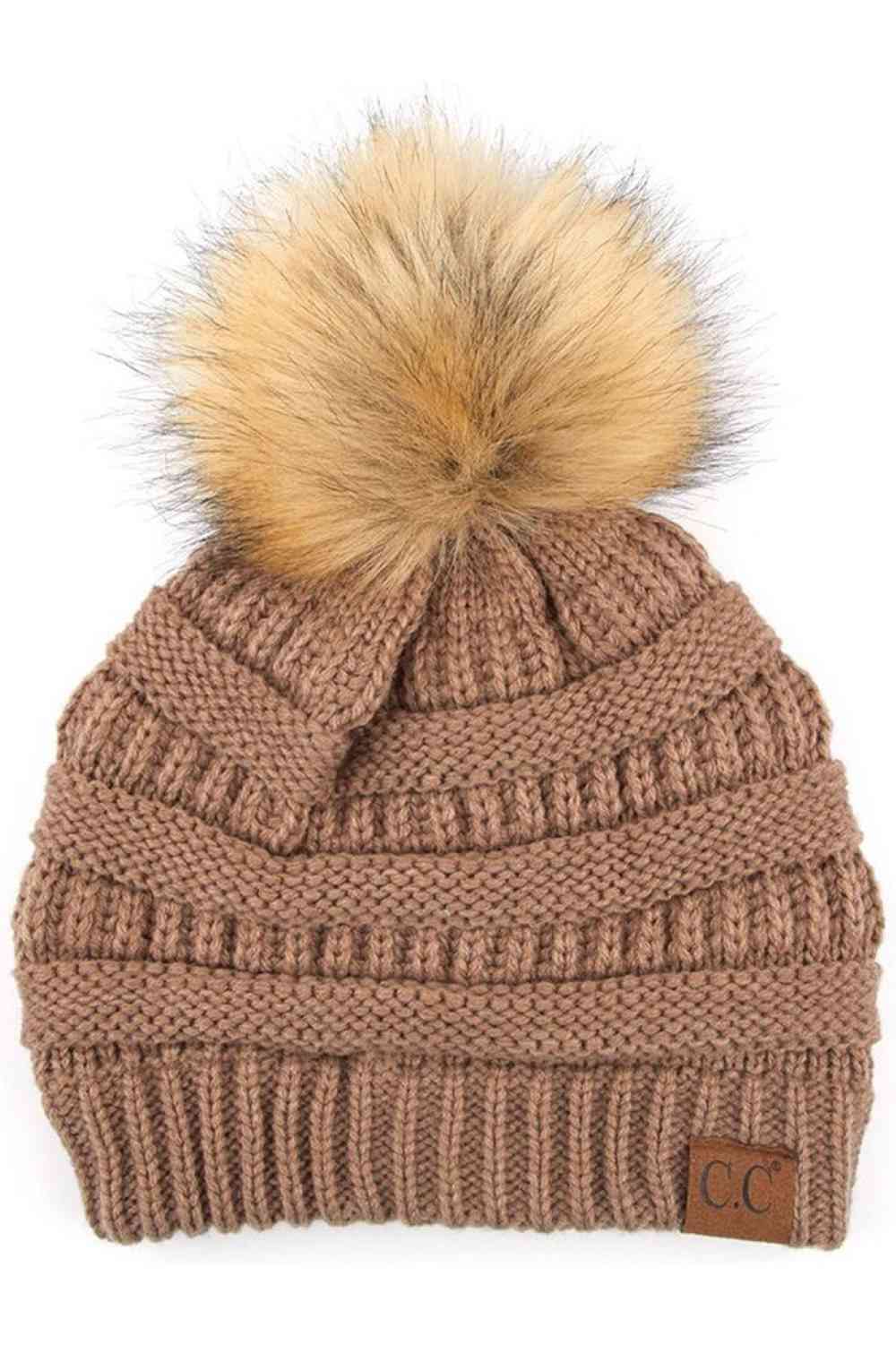 Taupe Stay warm and cozy with this classic C.C Pom Pom Knit Beanie, crafted from 100% soft acrylic for all-day comfort. The ribbed knit design adds texture and durability, while the signature pom pom on top brings a playful touch to any winter outfit. One size fits most, making it the perfect accessory for everyone. Ideal for cold weather adventures or casual everyday wear.