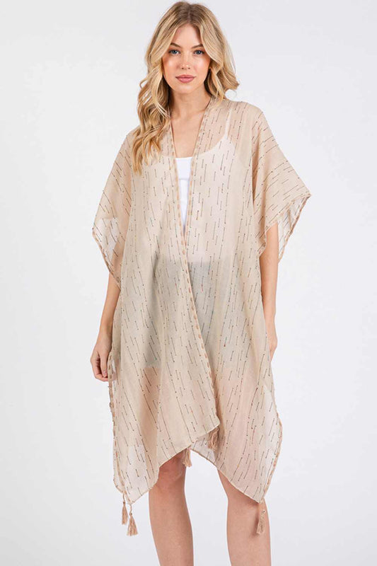 Taupe Effortless summer style meets vibrant detail with this lightweight kimono cover-up. Crafted from 100% polyester, it features colorful stitch trim and playful tassels that add movement and personality to any beach or poolside look. The generous 31" x 35" dimensions provide comfortable coverage over swimwear or casual outfits. Perfect for layering during warm-weather getaways, this versatile piece transitions seamlessly from day to evening. Machine washable and designed for easy care, it's an essential 
