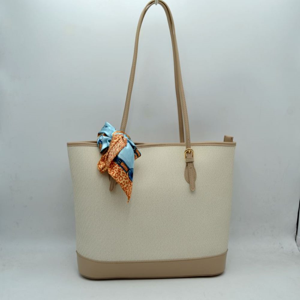 Taupe Step out in style with this sophisticated and timeless tote bag. Designed with an understated chevron-style textured weave, this bag seamlessly blends classic elegance with everyday functionality. Perfect for work, travel, or upscale weekend outings, it comes complete with a vibrant, playful silk-style scarf wrapped around the handle for an instant touch of Parisian chic.