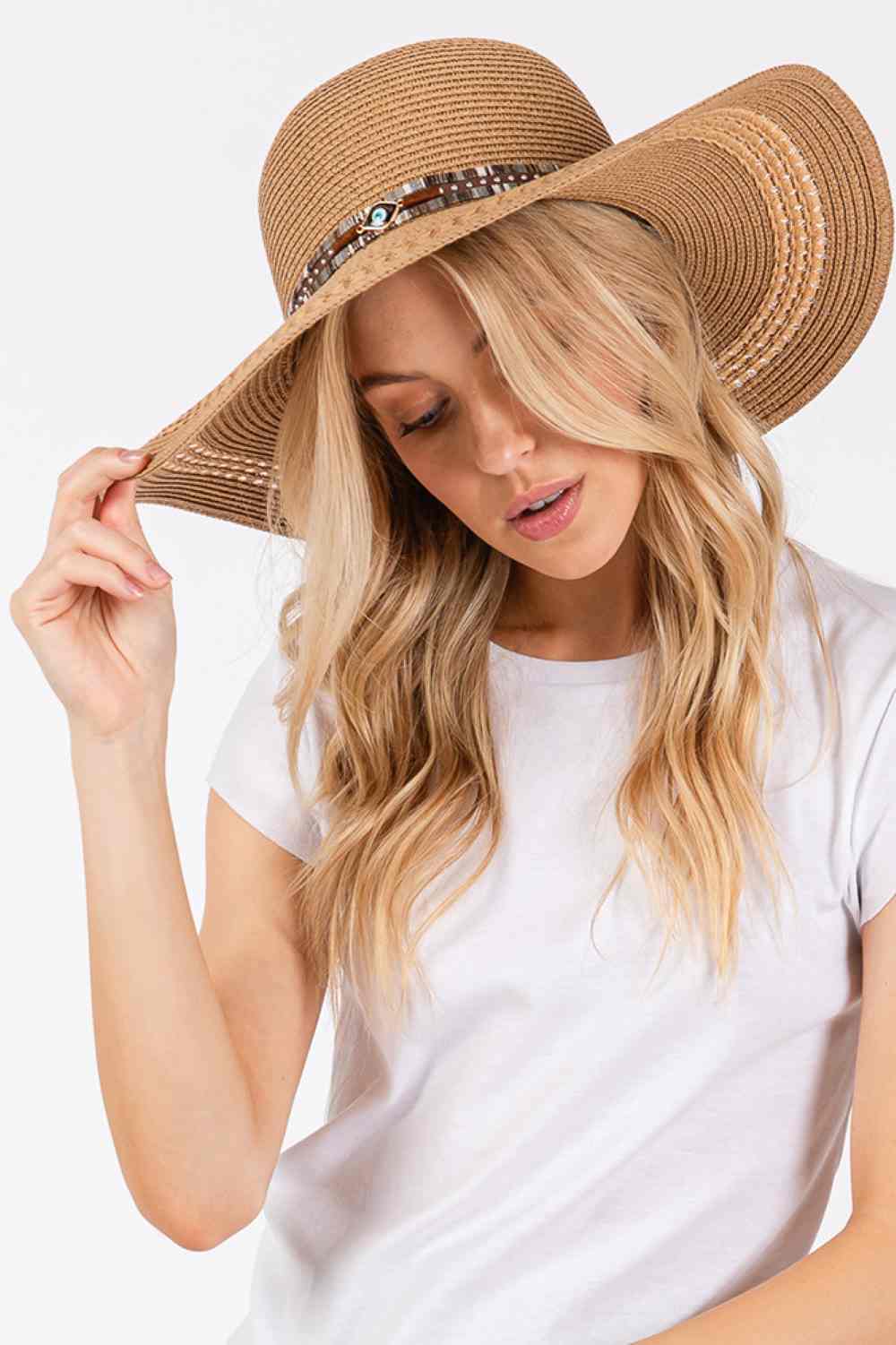 Taupe Stay protected from the sun in style with this wide-brim straw hat featuring an eye-catching evil eye and multi-design band. Crafted from 100% paper material, the 5" brim delivers excellent UV protection while the lightweight construction keeps you cool during summer outings.