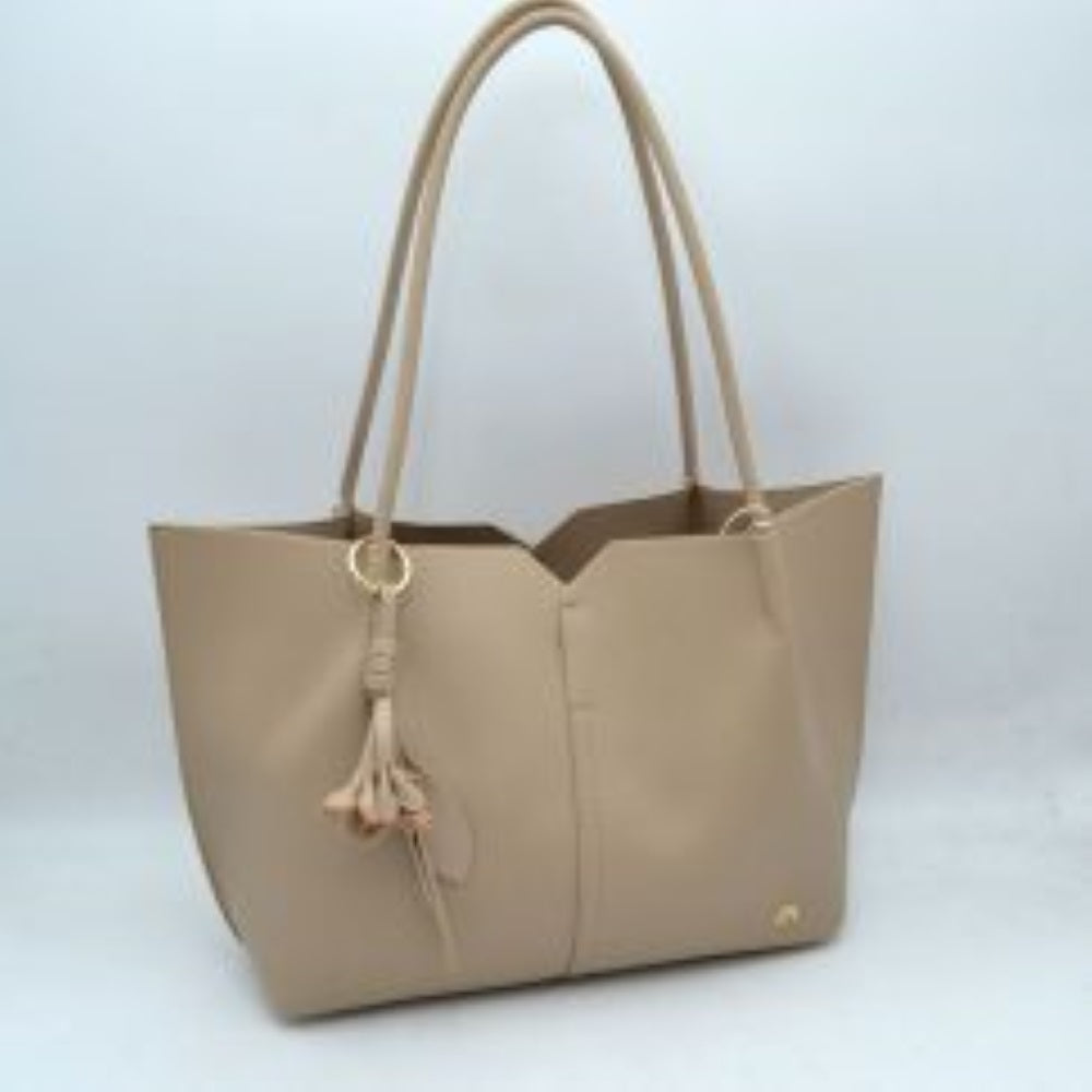 Taupe Bring a clean, contemporary aesthetic to your daily wardrobe with this sophisticated tote bag. Featuring a distinctive geometric cutout design along the upper trim, this shoulder bag offers a modern architectural edge while remaining perfectly functional. The smooth, textured exterior is detailed with subtle vertical center stitching and a small, polished metallic logo accent on the lower corner. Designed for comfort and convenience