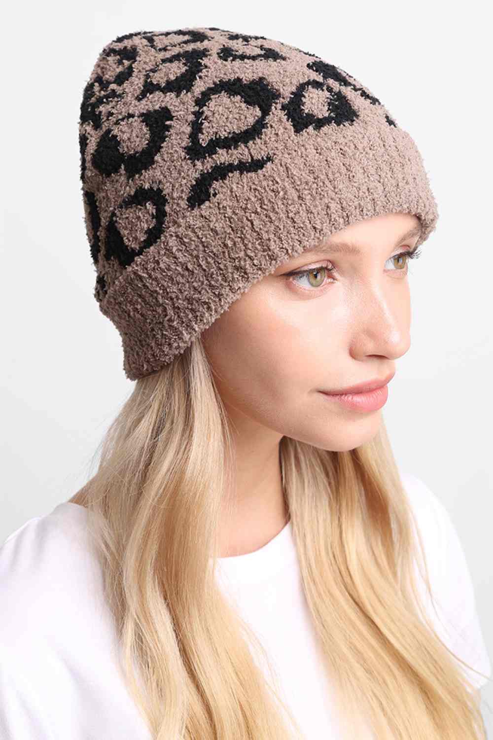 Taupe Leopard Print with Ribbed Trim Beanie features a bold leopard print design accented with a ribbed trim for a stylish, trendy winter look. Made with a soft stretch fit, it provides cozy warmth while adding playful flair to your cold-weather outfits.
