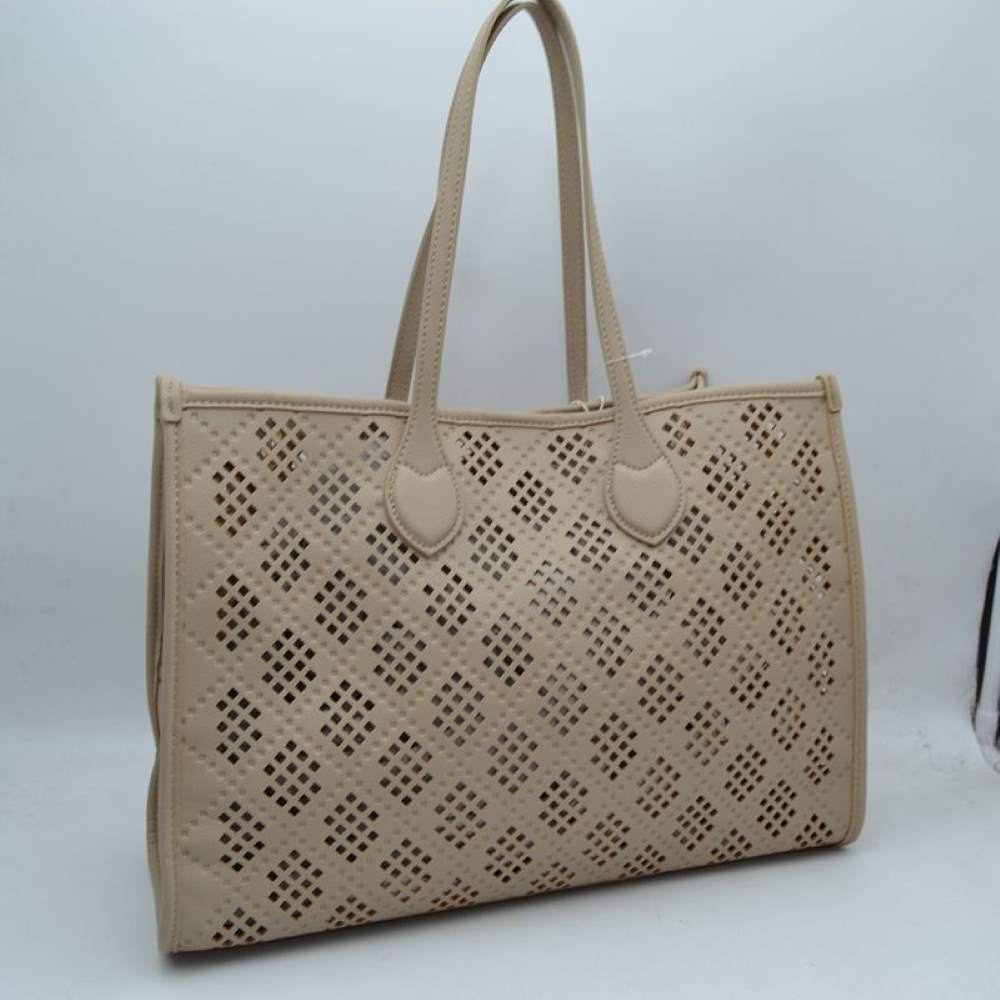 Taupe Elevate your accessory game with this stunning black perforated tote. Combining architectural precision with everyday practicality, this bag features an intricate laser-cut lattice design that offers a modern, airy feel while maintaining a structured, high-end silhouette. Whether you're heading to a business meeting or a weekend brunch, this versatile tote is the perfect blend of edgy detail and classic sophistication.