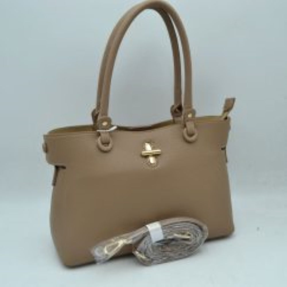 Taupe This everyday handbag features a structured silhouette with a distinctively textured exterior surface. Designed for versatile carrying options, it includes dual rounded top handles attached via metallic hardware studs alongside a separate, detachable shoulder strap. The front panel is accented with a prominent metallic turn-lock closure detail.