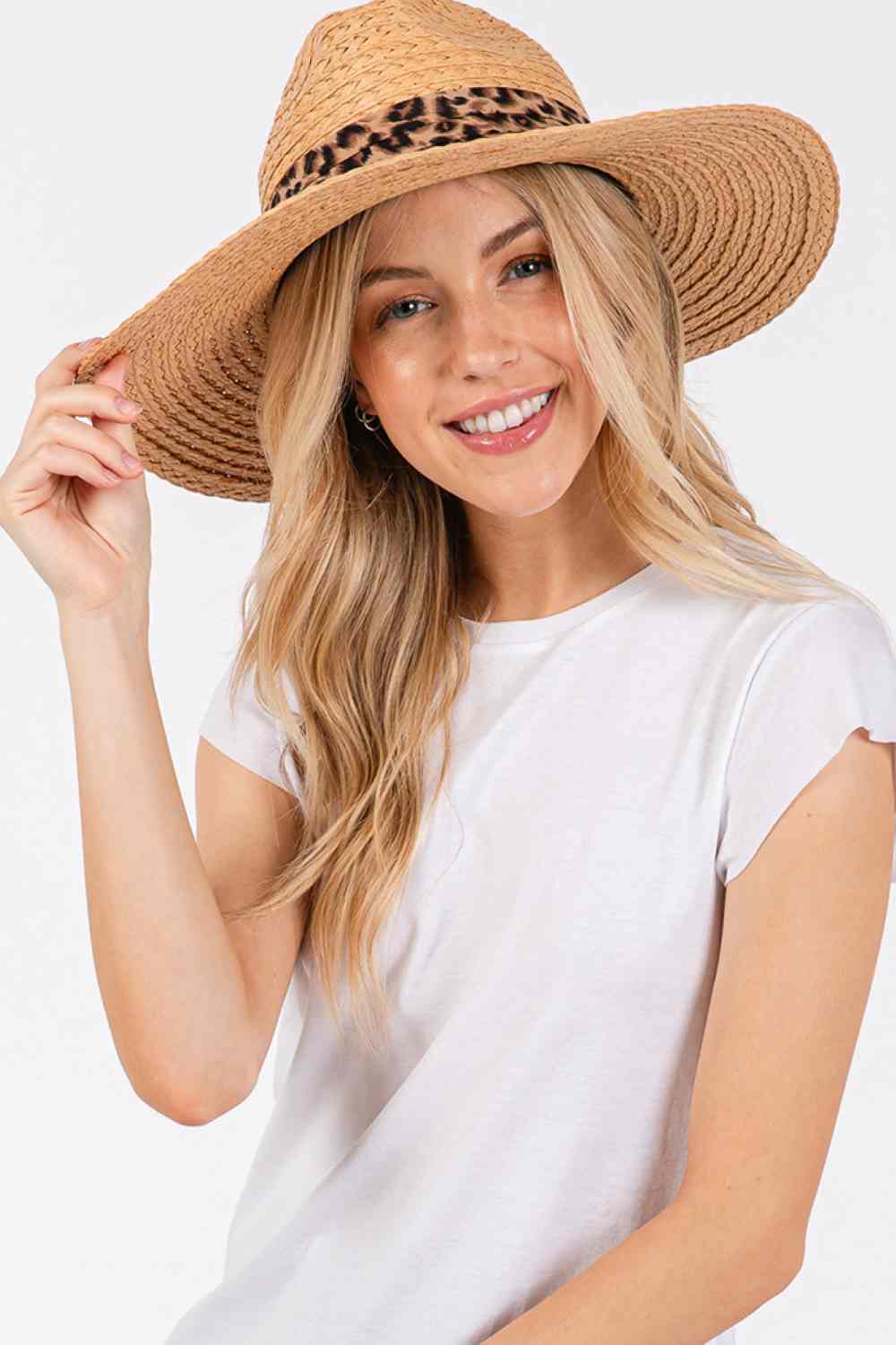 Taupe Leopard Trim Band Summer Straw Sun Hat features a distinctive leopard trim band that adds a touch of wild elegance to your warm-weather wardrobe. The wide brim provides optimal sun protection while maintaining a sophisticated silhouette. Lightweight and breathable construction ensures comfort during extended outdoor wear.