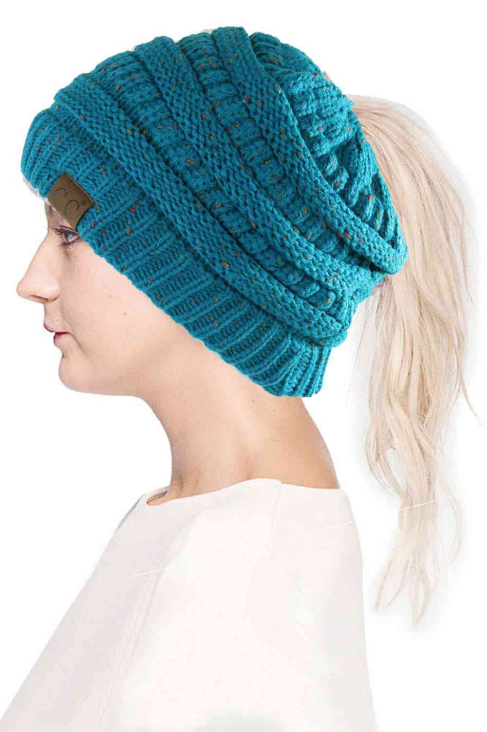 Teal The C.C Confetti Ponytail Messy Bun Beanie features a soft knit design with subtle confetti flecks for a fun, playful look. Designed with a convenient opening for ponytails or messy buns, it keeps you warm while allowing you to style your hair comfortably.