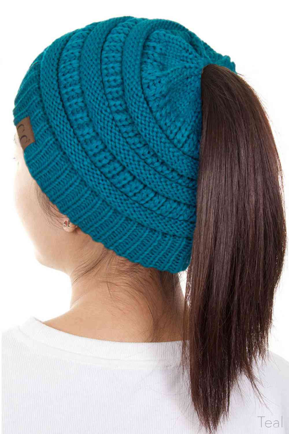 Teal The C.C Solid Color Ponytail Messy Bun Beanie combines comfort with versatility for effortless everyday style. Crafted from 100% soft acrylic, this beanie features an open crown design that accommodates ponytails and messy buns while keeping you warm. The one-size-fits-most construction ensures a secure, flattering fit for virtually anyone. Perfect for casual outings, workouts, or relaxed weekends, this practical accessory transitions seamlessly from season to season.