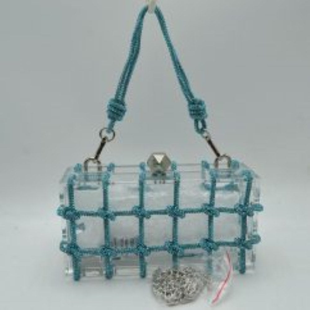 Teal This unique everyday box clutch bag features a transparent structured body enclosed in a distinctive knotted cage overlay. Designed for specialized daily or evening use, the main storage compartment is secured by a top frame with a geometric metallic clasp closure. It offers versatile carrying options, equipped with a flexible cord top handle attached to the top panels via polished metal loops, alongside a separate metallic chain strap included at the base.