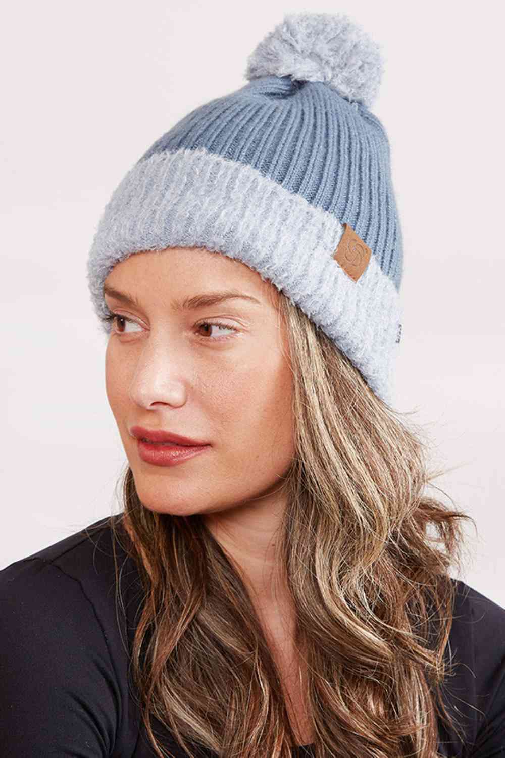 Teal Cozy up this season with our Ribbed Brim Button Pom Beanie, designed for warmth and style. Crafted from 100% acrylic, this soft knit hat features a classic ribbed texture, decorative buttons, and a charming pom pom on top.