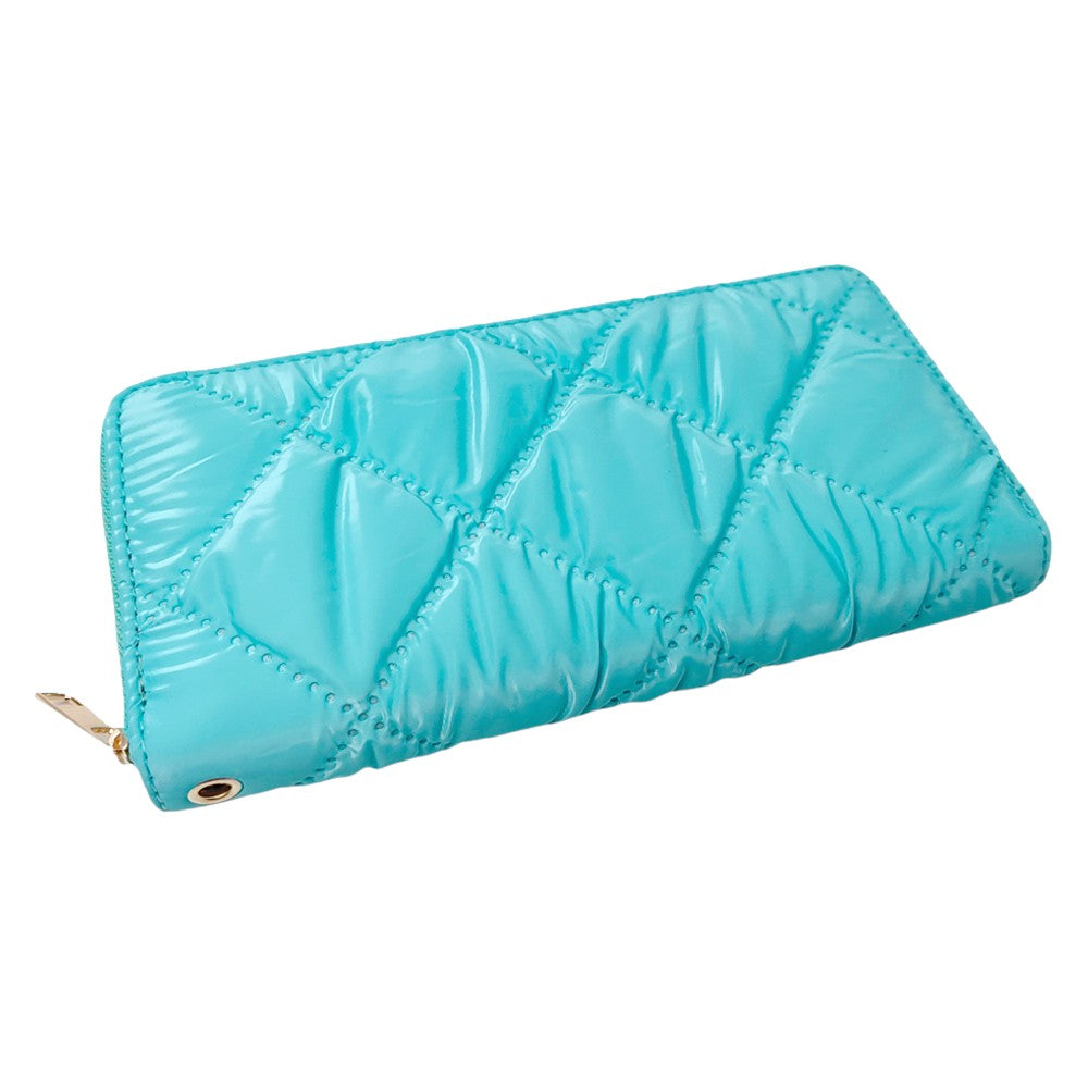 Turquoise Shiny Faux Leather Padded Wallet with Wristlet offers a sleek and stylish solution for storing your essentials. Its shiny faux leather material adds a touch of sophistication, while the padded design keeps your valuables safe. The attached wristlet also provides convenience and hands-free carrying. 