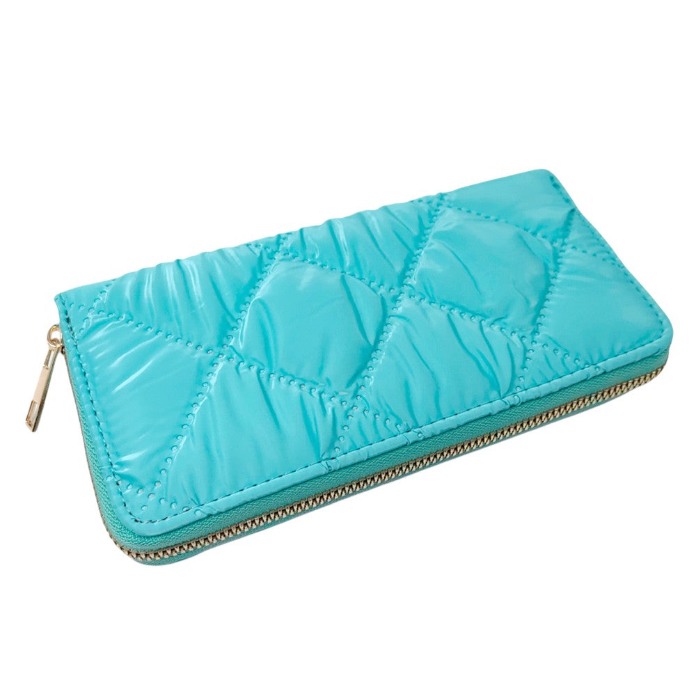 Turquoise Shiny Faux Leather Padded Wallet with Wristlet offers a sleek and stylish solution for storing your essentials. Its shiny faux leather material adds a touch of sophistication, while the padded design keeps your valuables safe. The attached wristlet also provides convenience and hands-free carrying. 