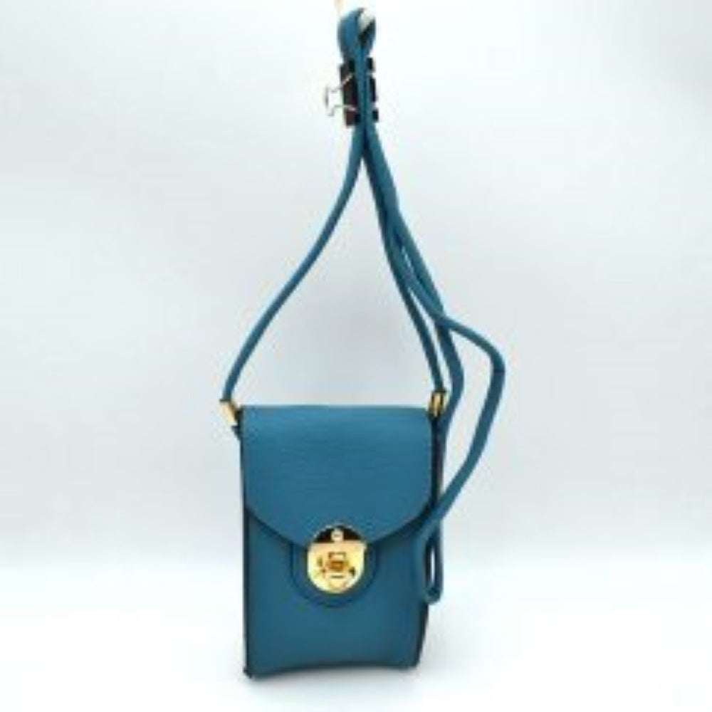 Turquoise  This compact crossbody pouch features a textured pebbled finish and a structured vertical silhouette, making it ideal for keeping small essentials and phones handy while on the go. Designed with a front flap closure, it is secured with an ornate, metallic round turn-lock hardware accent. A long, slender matching strap allows for effortless hands-free carrying across the body or over the shoulder.