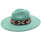 Turquoise Tribal Band Panama Hat features an authentic tribal band motif executed with meticulous attention to detail. Constructed using select-grade natural fibers through a proprietary weaving process that ensures exceptional breathability and longevity. The architectural crown and precision-angled brim provide optimal facial shading while maintaining classic proportions. The tribal patterning represents a harmonious fusion of ethnographic influence and contemporary design sensibility, elevating this piec