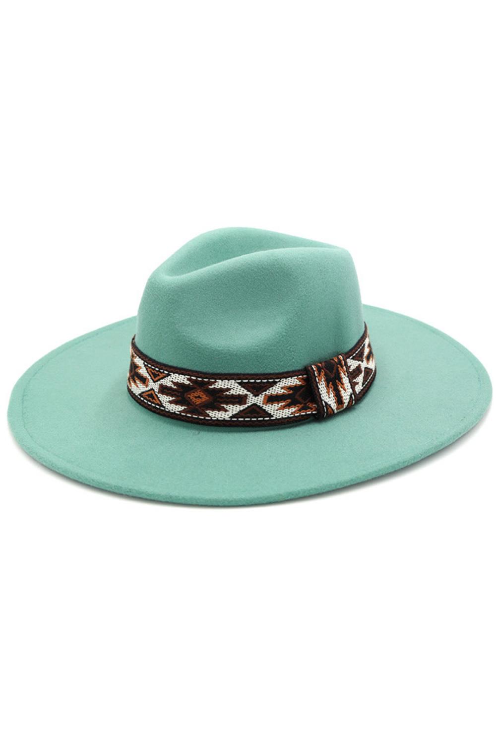 Turquoise Tribal Band Panama Hat features an authentic tribal band motif executed with meticulous attention to detail. Constructed using select-grade natural fibers through a proprietary weaving process that ensures exceptional breathability and longevity. The architectural crown and precision-angled brim provide optimal facial shading while maintaining classic proportions. The tribal patterning represents a harmonious fusion of ethnographic influence and contemporary design sensibility, elevating this piec