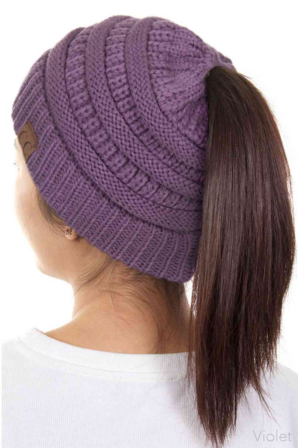 Violet The C.C Solid Color Ponytail Messy Bun Beanie combines comfort with versatility for effortless everyday style. Crafted from 100% soft acrylic, this beanie features an open crown design that accommodates ponytails and messy buns while keeping you warm. The one-size-fits-most construction ensures a secure, flattering fit for virtually anyone. Perfect for casual outings, workouts, or relaxed weekends, this practical accessory transitions seamlessly from season to season.