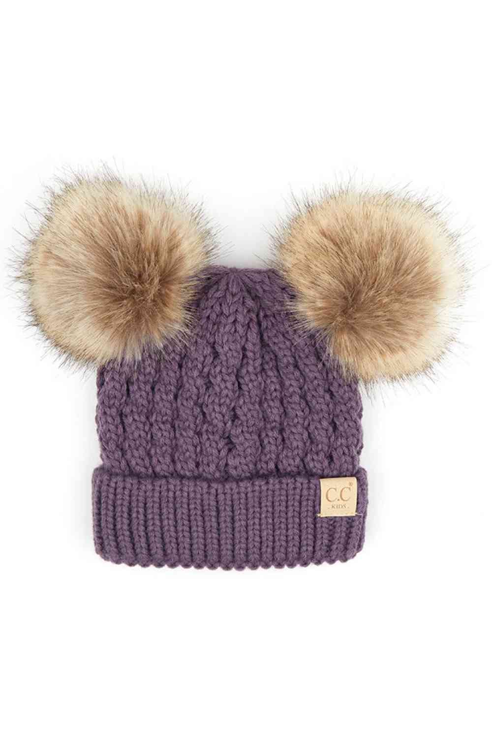 Violet Keep your child warm and stylish with this C.C Kids Double Pom Pom Beanie. Featuring an all-over cable knit pattern and dual pom poms for extra charm, it's the perfect accessory for chilly days.