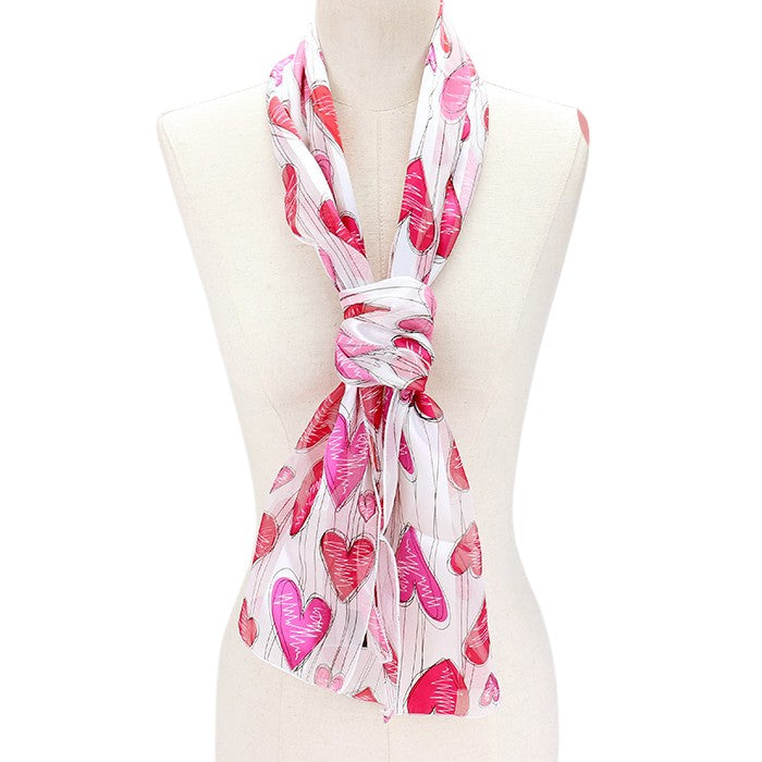 White Silk Feel Striped Heart Pattern Scarves are designed with a soft and luxurious silk-like material that guarantees comfortable and lightweight wear. The elegant striped heart pattern adds a touch of sophistication to any outfit. Perfect as a gift or a stylish addition to your wardrobe.